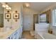 Bathroom with a soaking tub, walk-in shower, and vanity, offering a relaxing space at 3621 Portland Trail Dr, Suwanee, GA 30024