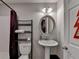 Bathroom with a pedestal sink, modern lighting, and a shower with a burgundy curtain at 3621 Portland Trail Dr, Suwanee, GA 30024