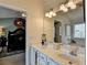 Bright bathroom with double vanity, mirrors, and a glimpse into the well-decorated bedroom at 3621 Portland Trail Dr, Suwanee, GA 30024