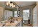 Bright bathroom with double vanity sinks, large mirror, and natural light at 3621 Portland Trail Dr, Suwanee, GA 30024