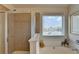 Bright bathroom featuring tiled shower, soaking tub with window view at 3621 Portland Trail Dr, Suwanee, GA 30024