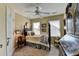 Cozy bedroom featuring a black four-poster bed, window, and unique decor at 3621 Portland Trail Dr, Suwanee, GA 30024