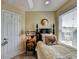 A bedroom featuring a decorative bedframe, bedside table, and bright window at 3621 Portland Trail Dr, Suwanee, GA 30024