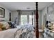 Stylish bedroom featuring four-poster bed and natural light from bright windows at 3621 Portland Trail Dr, Suwanee, GA 30024