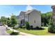 Attractive home showcasing neutral siding, well-maintained lawn, and complemented by mature trees at 3621 Portland Trail Dr, Suwanee, GA 30024