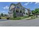 Charming two-story home featuring a welcoming front porch with stone accents and manicured landscaping at 3621 Portland Trail Dr, Suwanee, GA 30024