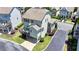 Aerial view of a charming home with a back deck, patio, and well-manicured landscaping at 3621 Portland Trail Dr, Suwanee, GA 30024