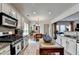 Open concept kitchen with stainless steel appliances and views of the dining and living areas at 3621 Portland Trail Dr, Suwanee, GA 30024