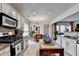 Well-appointed kitchen with stainless steel appliances, granite counters, and eat-in dining area at 3621 Portland Trail Dr, Suwanee, GA 30024