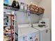 Functional laundry room with washer, dryer, and ample shelving for storage at 3621 Portland Trail Dr, Suwanee, GA 30024