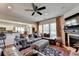 Open-concept living room showcasing a fireplace, comfortable seating, and stylish decor and view to the kitchen at 3621 Portland Trail Dr, Suwanee, GA 30024