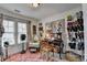 Well-lit office with vintage decor, patterned rug, window and shelving at 3621 Portland Trail Dr, Suwanee, GA 30024