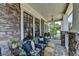 Inviting front porch with stone accents, comfortable seating, and stylish decor at 3621 Portland Trail Dr, Suwanee, GA 30024