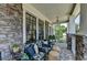 Cozy front porch with stone details, comfortable seating, and charming outdoor decor at 3621 Portland Trail Dr, Suwanee, GA 30024