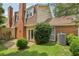 Spacious backyard with a stone paver patio, brick facade, and manicured lawn at 107 Mary Gay Ct, Decatur, GA 30030
