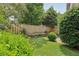 Well-maintained backyard with mature shrubbery, wood privacy fence, and small patio at 107 Mary Gay Ct, Decatur, GA 30030