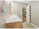 Bathroom featuring wood vanity, large mirror, and view into carpeted bedroom at 107 Mary Gay Ct, Decatur, GA 30030