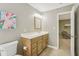 Bathroom with tile floors, wooden vanity, and open door to carpeted bedroom at 107 Mary Gay Ct, Decatur, GA 30030