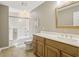 Bathroom featuring wooden vanity, shower with glass door, and neutral finishes at 107 Mary Gay Ct, Decatur, GA 30030