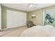 The bedroom has an accent wall, a gray chair, and big, bright windows at 107 Mary Gay Ct, Decatur, GA 30030