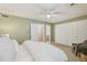 Spacious bedroom with plush carpeting, ceiling fan, and a view into bathroom at 107 Mary Gay Ct, Decatur, GA 30030