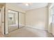 Beige carpeted bedroom boasting natural light and a closet with mirrored doors at 107 Mary Gay Ct, Decatur, GA 30030