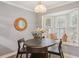 Cozy breakfast nook with a bay window seat, round table, pendant light, and neutral tones at 107 Mary Gay Ct, Decatur, GA 30030