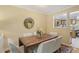 Inviting dining room featuring a dark wood table, white chairs, and a view into the kitchen at 107 Mary Gay Ct, Decatur, GA 30030