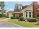 Charming home featuring a brick facade, well-manicured lawn and two-car garage on a sunny day at 107 Mary Gay Ct, Decatur, GA 30030