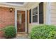 Inviting front entrance with glass door, brick accents, and manicured greenery for a welcoming curb appeal at 107 Mary Gay Ct, Decatur, GA 30030