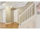 Hallway with wood floors, white trim and doors, and a staircase at 107 Mary Gay Ct, Decatur, GA 30030