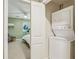 Laundry room with stackable washer and dryer with doorway view to carpeted bedroom at 107 Mary Gay Ct, Decatur, GA 30030