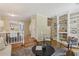 Elegant living room with hardwood floors, built-in bookshelves, and seamless access to the dining area at 107 Mary Gay Ct, Decatur, GA 30030