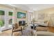 Cozy living room featuring a fireplace, light-colored walls, hardwood floors, and French doors leading to the outside at 107 Mary Gay Ct, Decatur, GA 30030