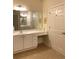 Bright bathroom featuring white cabinets, vanity and countertops, a large mirror, and a convenient makeup nook at 1301 Haven Cir, Douglasville, GA 30135