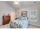 Spacious bedroom featuring a ceiling fan, shuttered windows, and comfortable furnishings at 1301 Haven Cir, Douglasville, GA 30135