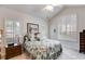 Bright bedroom featuring shuttered windows, ceiling fan, and comfortable furnishings at 1301 Haven Cir, Douglasville, GA 30135