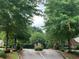 Gated entrance to the community, lined with trees and manicured landscaping at 1301 Haven Cir, Douglasville, GA 30135