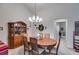Bright dining room featuring a chandelier, hardwood table, and built-in china cabinet at 1301 Haven Cir, Douglasville, GA 30135