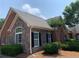 Exterior view of a brick and stone home with manicured bushes and an arched window at 1301 Haven Cir, Douglasville, GA 30135