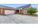 Brick home featuring a two-car garage, driveway, red front door, white trim, and a well-manicured lawn at 1301 Haven Cir, Douglasville, GA 30135