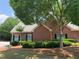 Charming brick home with stone accents, well-manicured landscaping and mature trees for shade at 1301 Haven Cir, Douglasville, GA 30135