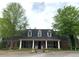 Charming brick clubhouse with white columns, dark shutters and lush landscaping at 1301 Haven Cir, Douglasville, GA 30135