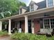 Inviting front porch with seating, framed by brick columns, offers a cozy outdoor living space at 1301 Haven Cir, Douglasville, GA 30135