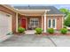 Cozy red brick home featuring a covered front porch with seating and a well-maintained yard at 1301 Haven Cir, Douglasville, GA 30135