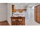 Open kitchen featuring a breakfast bar, wood cabinets, and neutral countertops at 1301 Haven Cir, Douglasville, GA 30135