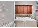 Practical laundry room with white washer, dryer, cabinets, and a water heater at 1301 Haven Cir, Douglasville, GA 30135
