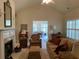 Comfortable living room with a cozy fireplace and views of the sunroom at 1301 Haven Cir, Douglasville, GA 30135