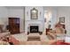 Bright living room featuring a fireplace, mantle with mirror, and comfortable seating area at 1301 Haven Cir, Douglasville, GA 30135