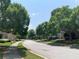 This suburban street is lined with mature trees and manicured lawns, creating a picturesque setting at 1301 Haven Cir, Douglasville, GA 30135